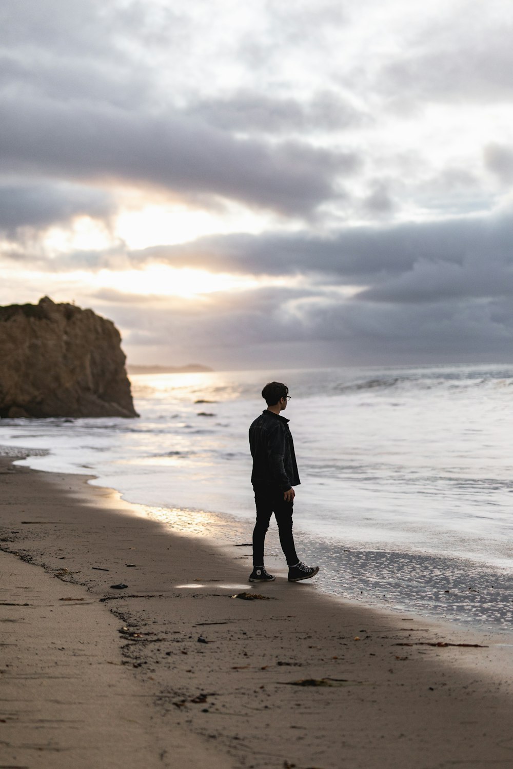 man standing on seashore