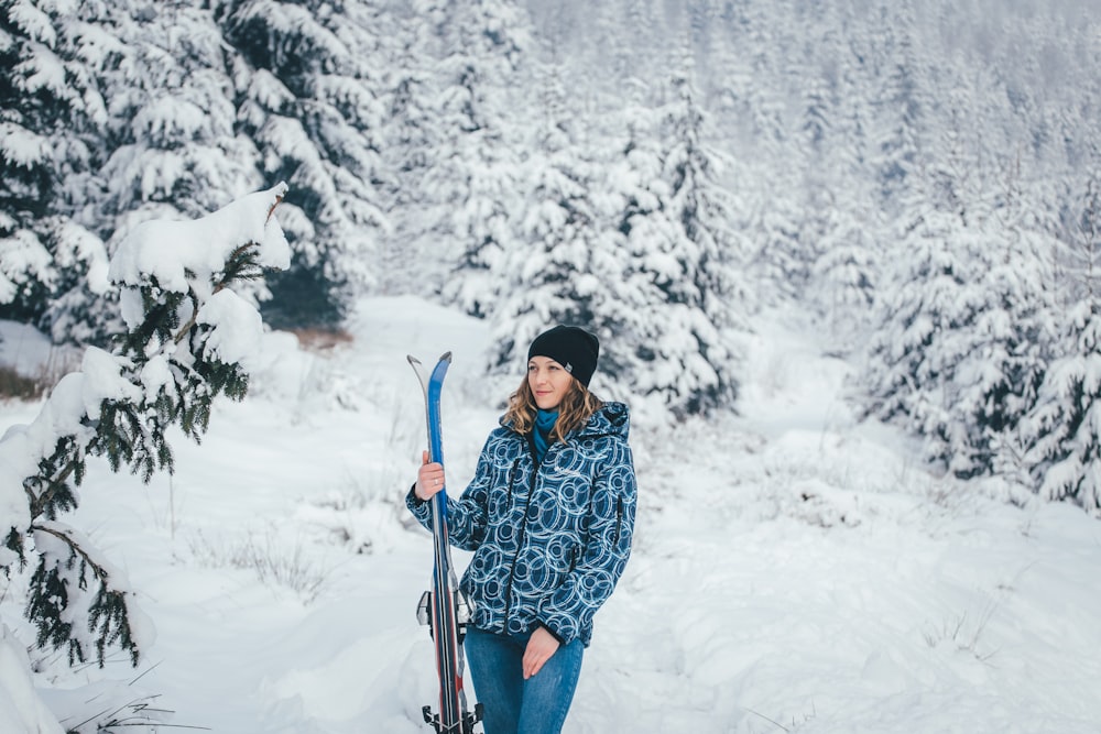 woman holding snow-skis at the hills during winter