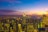 A vibrant 3D rendering of a futuristic cityscape at sunset.