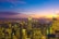 A vibrant 3D rendering of a futuristic cityscape at sunset.