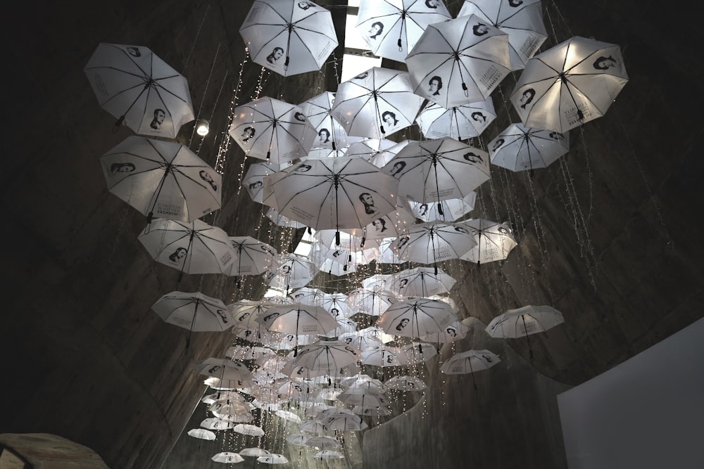 low angle view of white umbrellas hanging on the ceiling