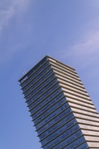 Modern corporate building exterior under a clear sky, symbolizing stability.