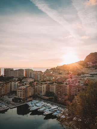 Sunset view over Cape Town harbor with a sleek yacht, symbolizing enduring legacy and global reach.