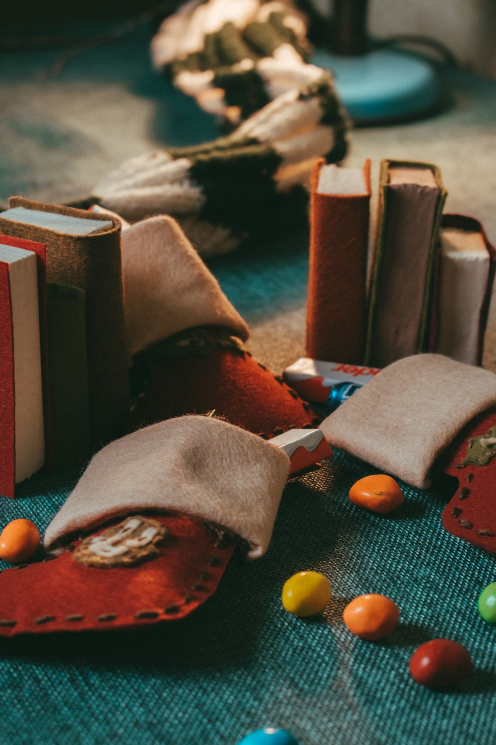 shallow focus photo of candies on blue textile