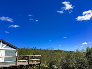 A sleek portable cabin set against a clear blue sky, highlighting its sturdy design.