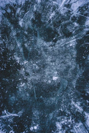 close up of dark blue ice surface with cracks