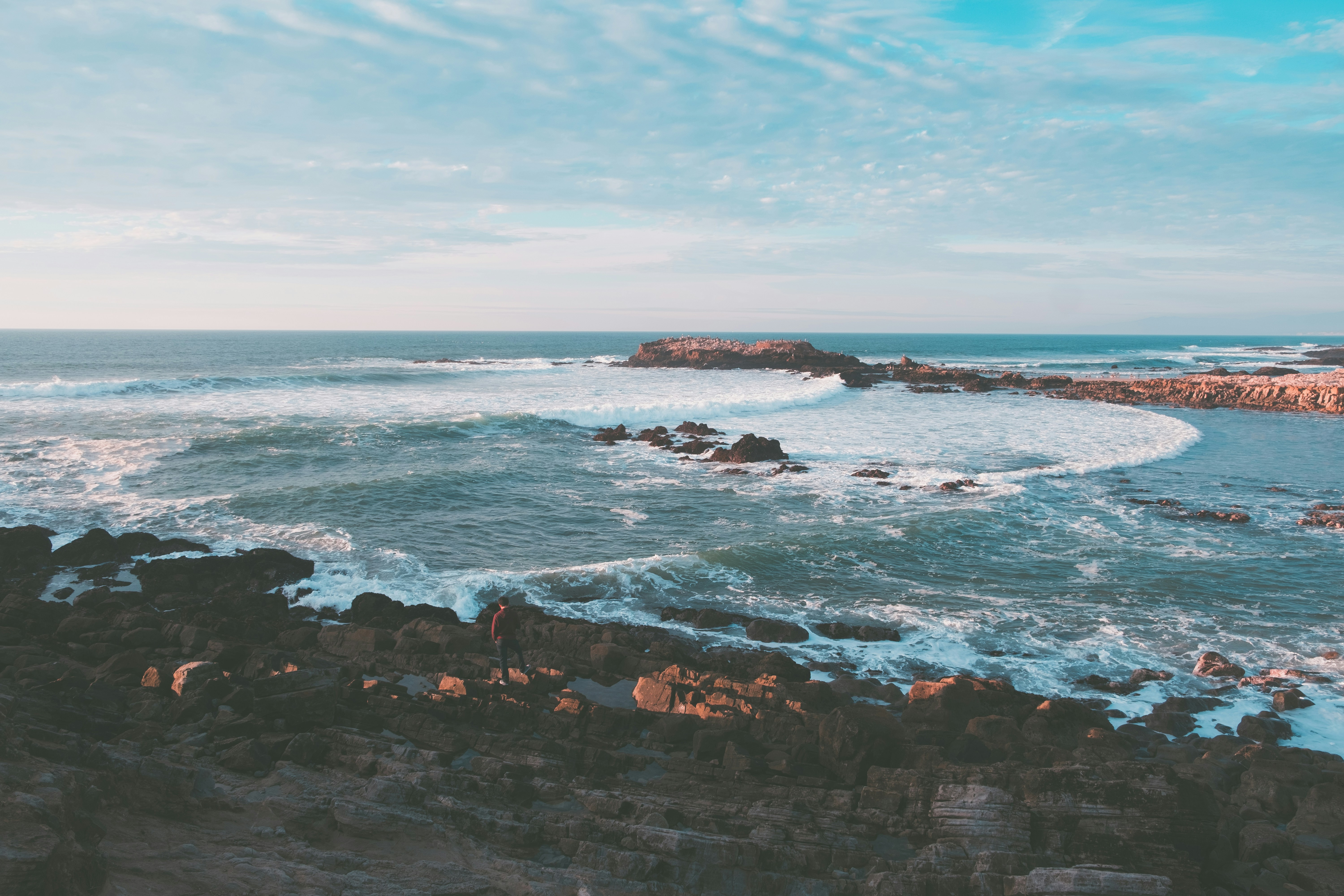 wavy ocean splashing on rock during daytime, 