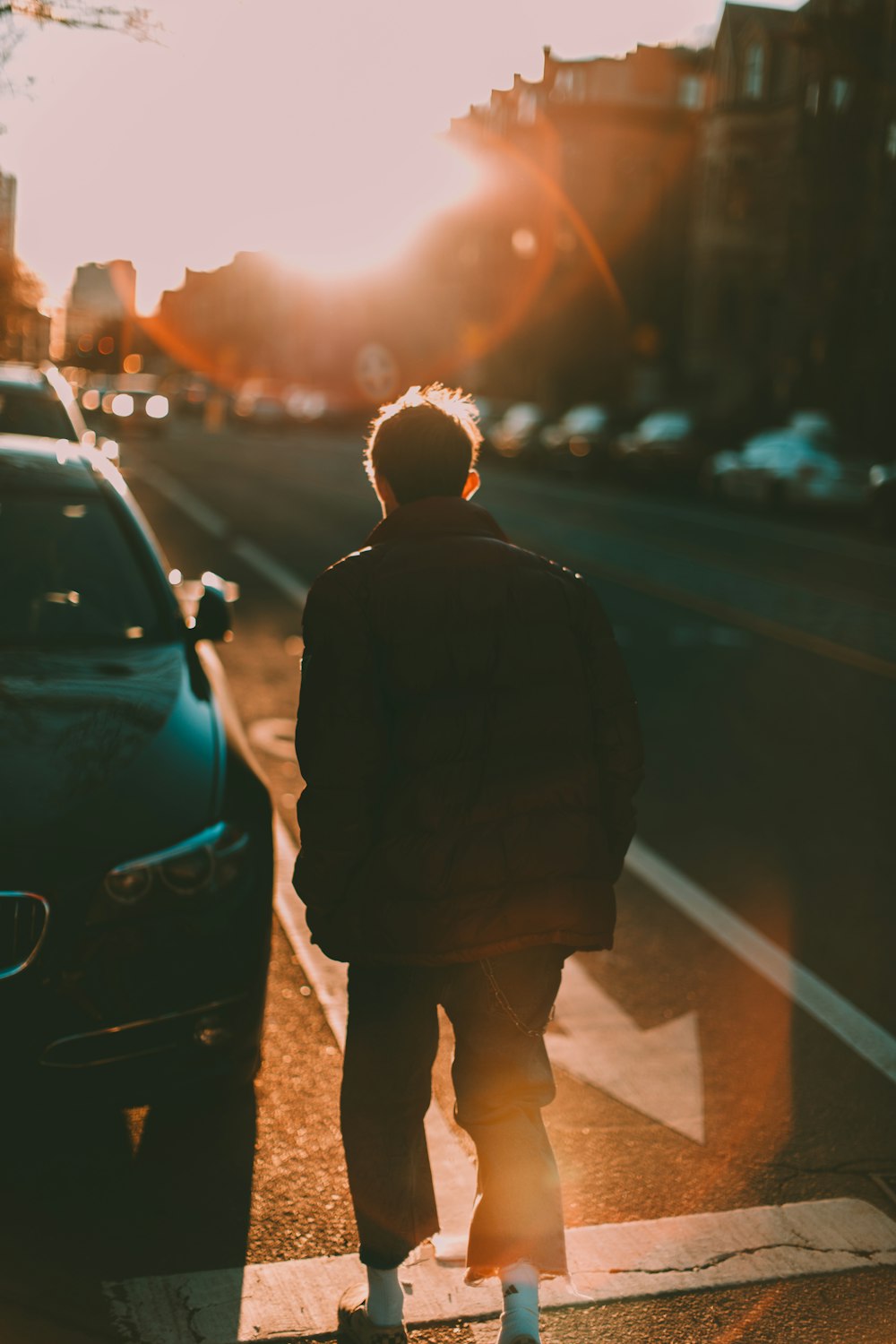 man standing beside black vehicle