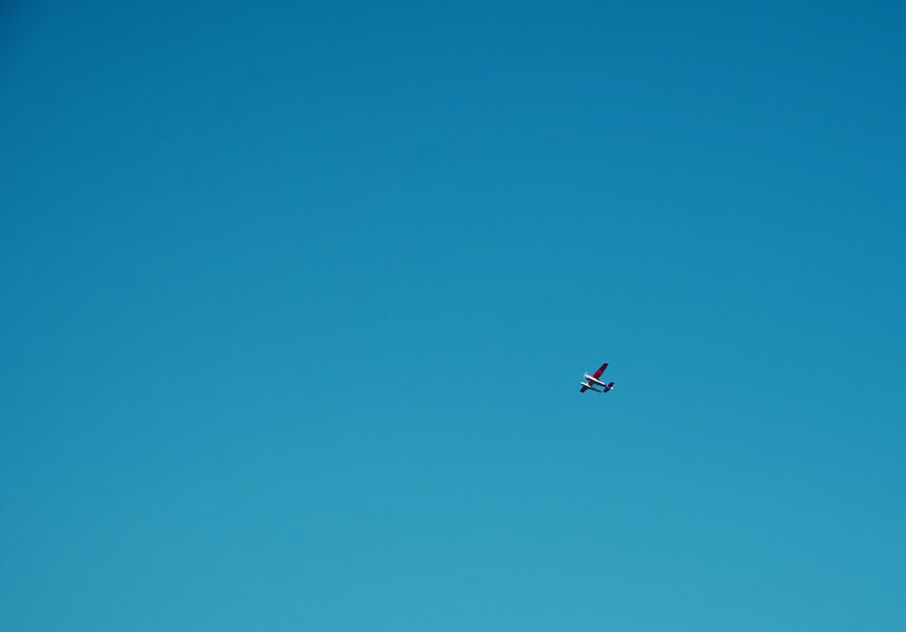 white plane under blue sky during daytime