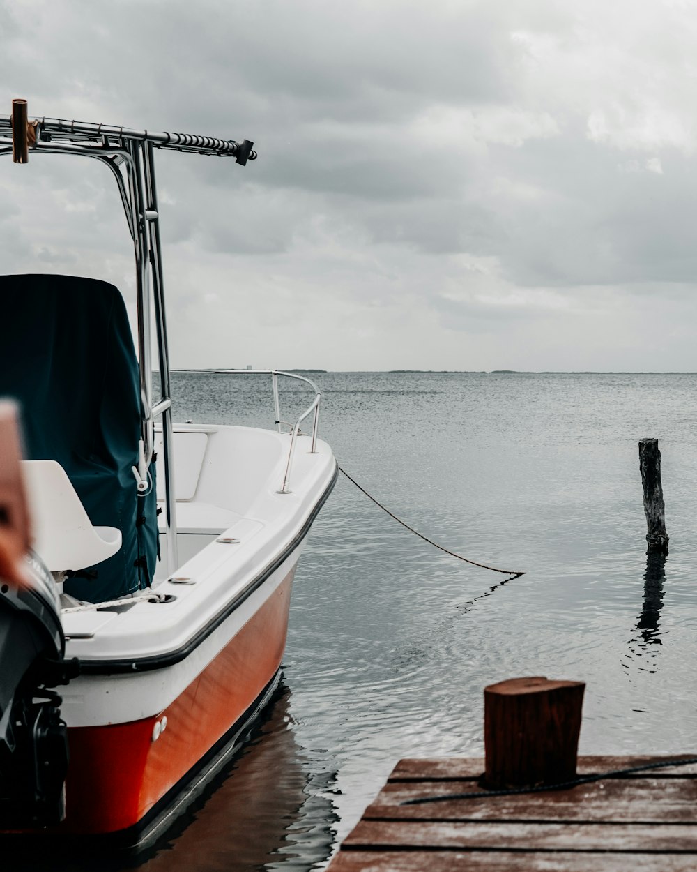 white and red outboard motor boat