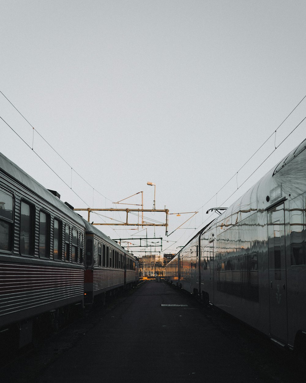 two gray passenger trains