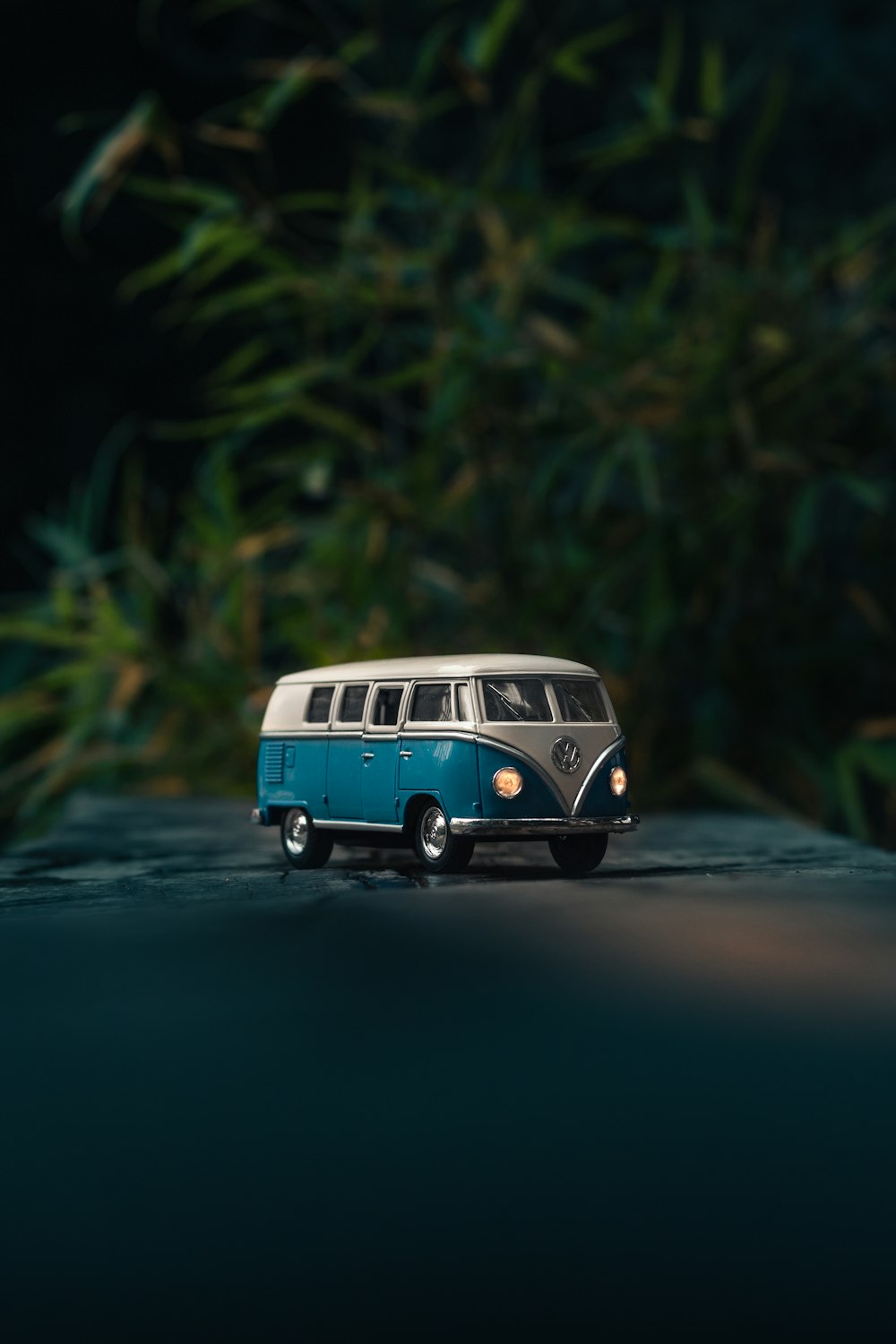 white and blue Volkswagen T1 van toy on gray surface