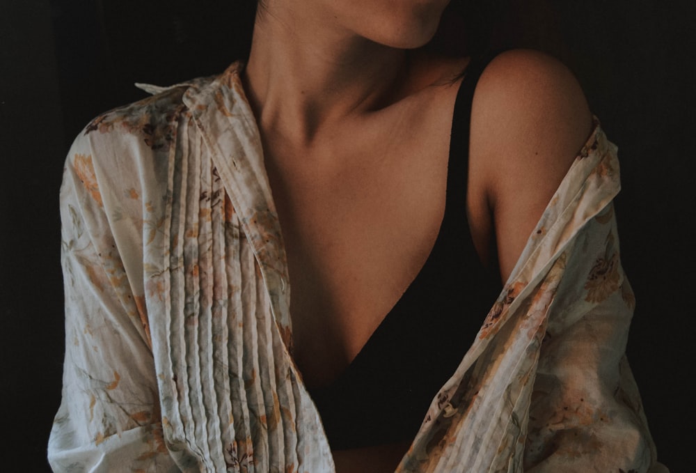 woman wearing gray and pink floral long-sleeved top and black tank top