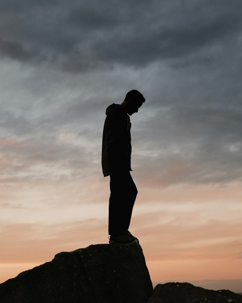 man standing on rock