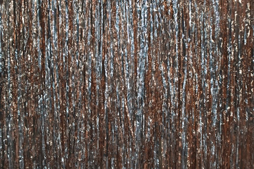 Bright copper sheets laid out flat, reflecting light in the factory.