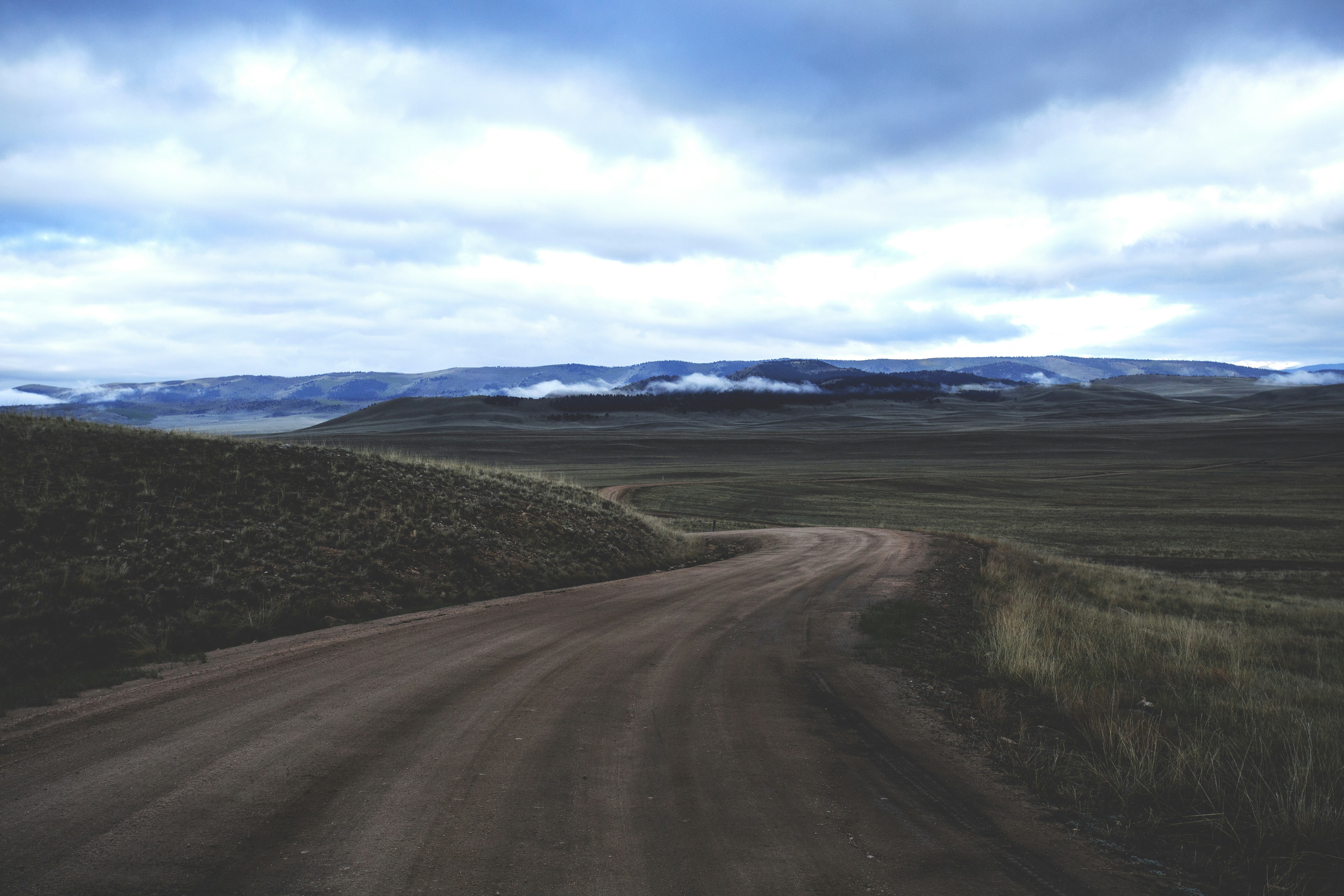 Lone, open dirt road through the Colorado high country.