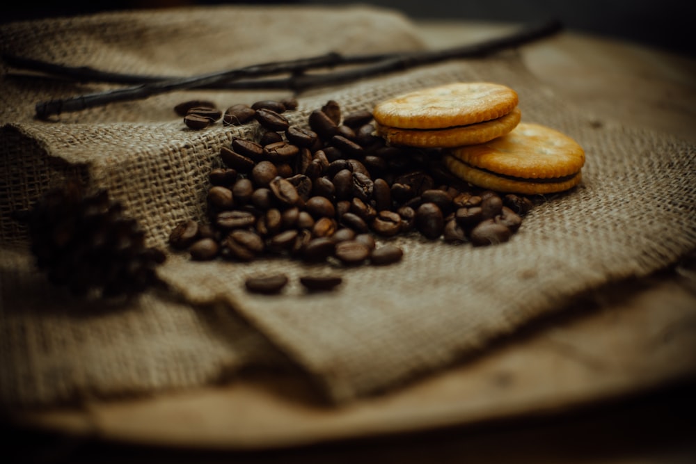 pair of brown biscuits and coffee beans on brown burlap sack