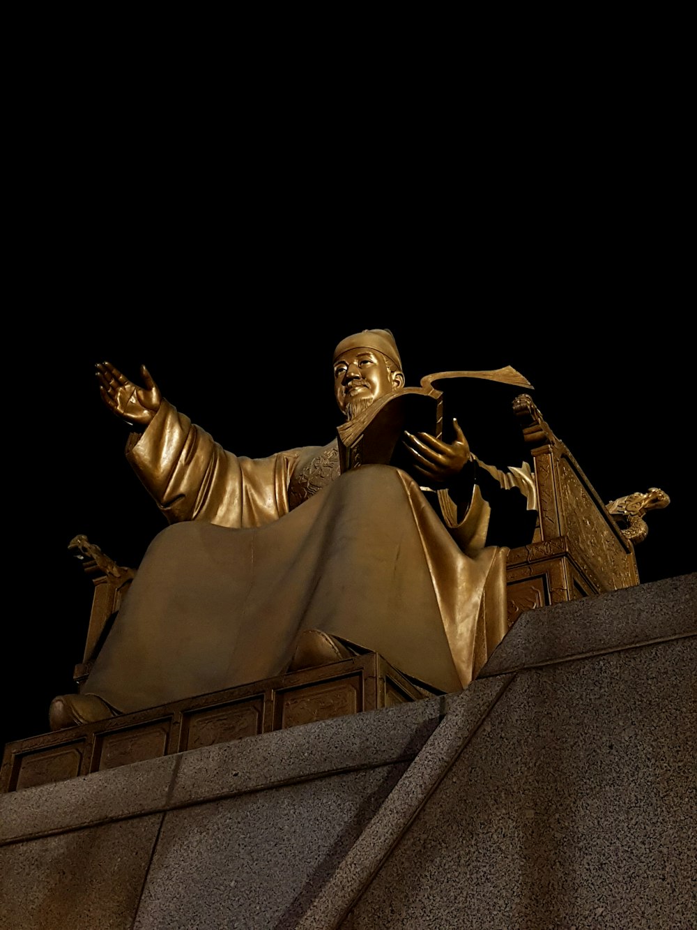 low-angle photography of sitting statue