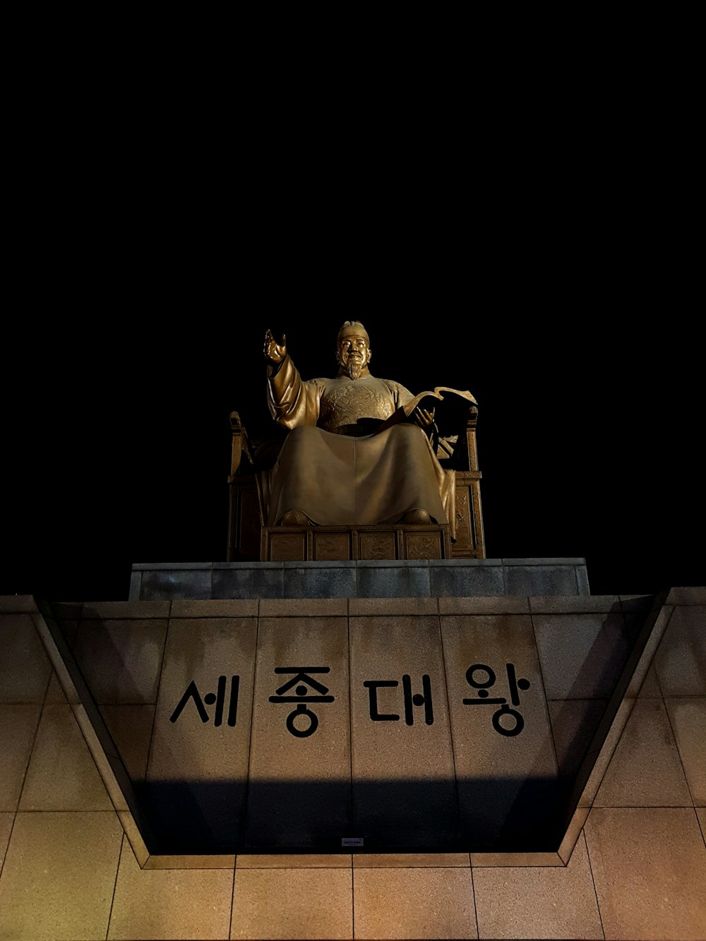 man sitting down statue