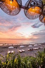 white parasol and lounge near seashores