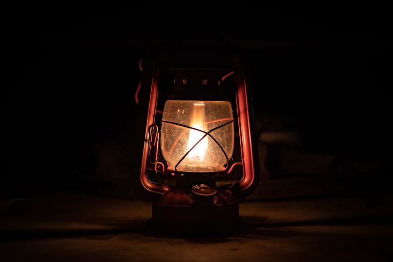 A camp lantern burning against the dark