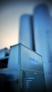Large industrial silos rise up in the background, with a metallic structure in the foreground featuring the text 'Revolution Series'. The overall appearance suggests a modern industrial facility.