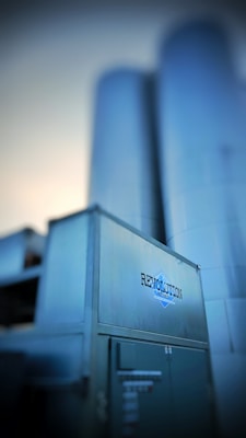 Large industrial silos rise up in the background, with a metallic structure in the foreground featuring the text 'Revolution Series'. The overall appearance suggests a modern industrial facility.