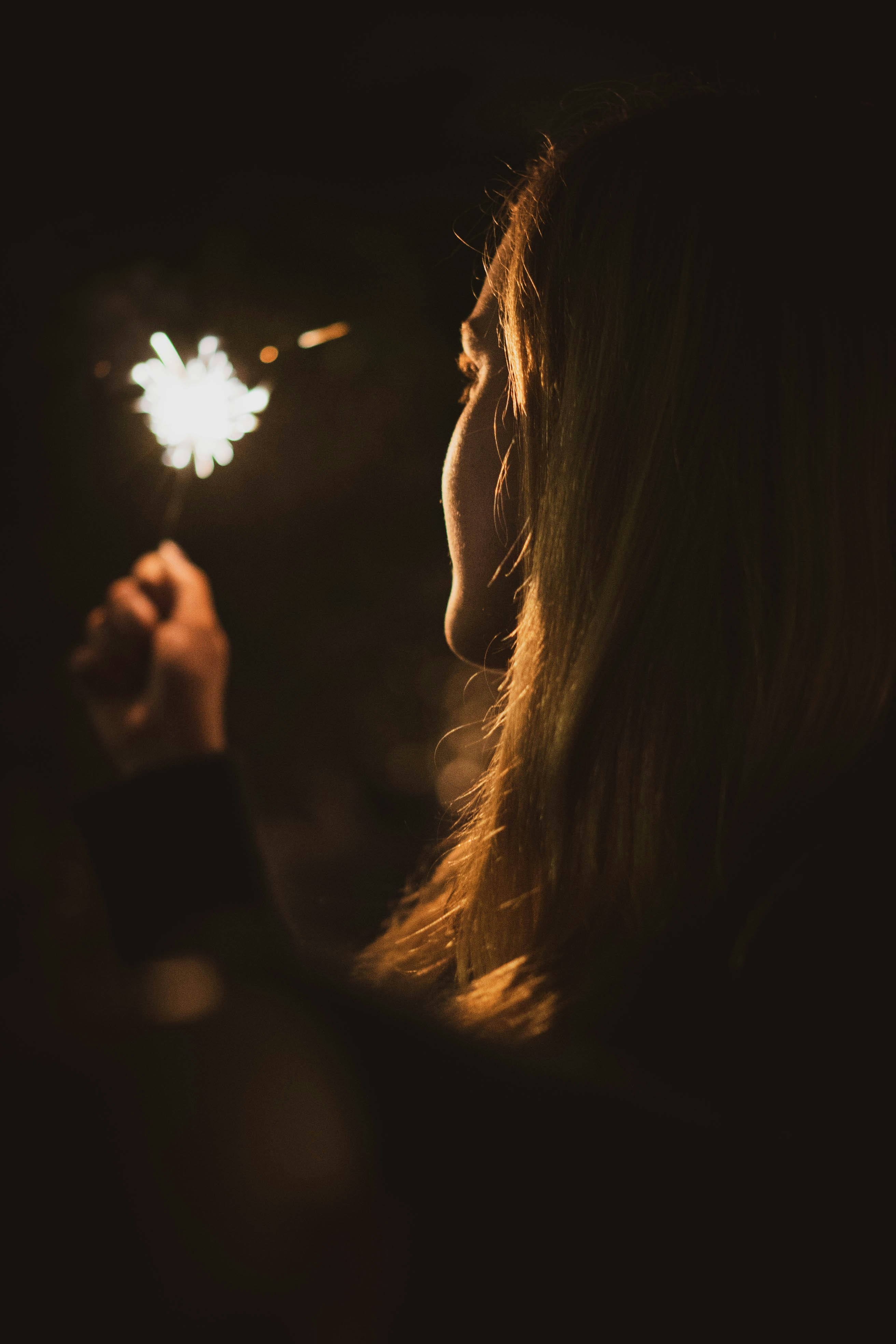 woman holding fireworks close-up photo