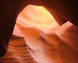 A serene view of Antelope Canyon's winding sandstone walls glowing in warm sunlight.