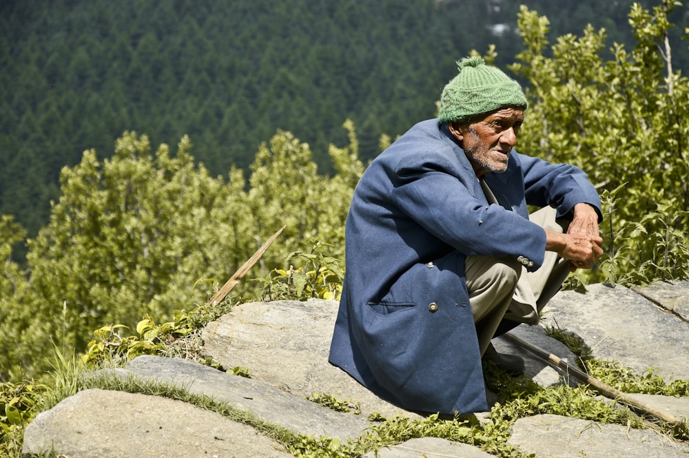 man wearing blue jacket across woods