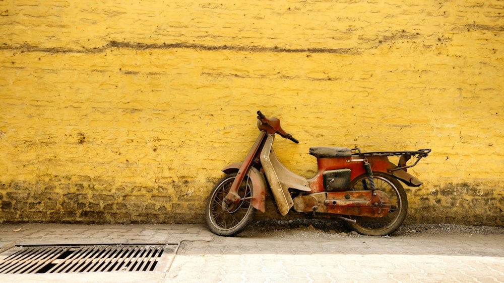 red underbone motorcycle parked on road