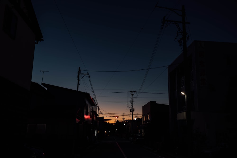 a city street at night with power lines above