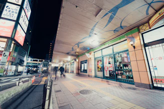 Evening view of Vibo Place’s illuminated signage and lively pedestrian walkways.