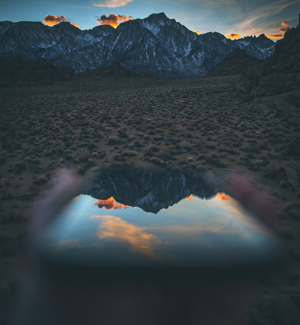 mountain under orange and blue sky