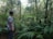 Man in casual clothes standing in a lush forest environment