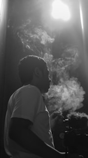 The silhouette of a member exhaling a slow plume of smoke in front of the speakeasy entrance hidden behind the coffee shop.