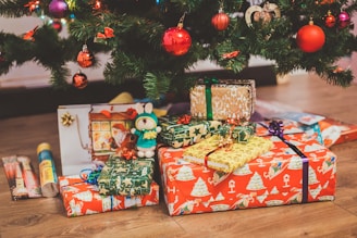 assorted-color gift box under Christmas tree