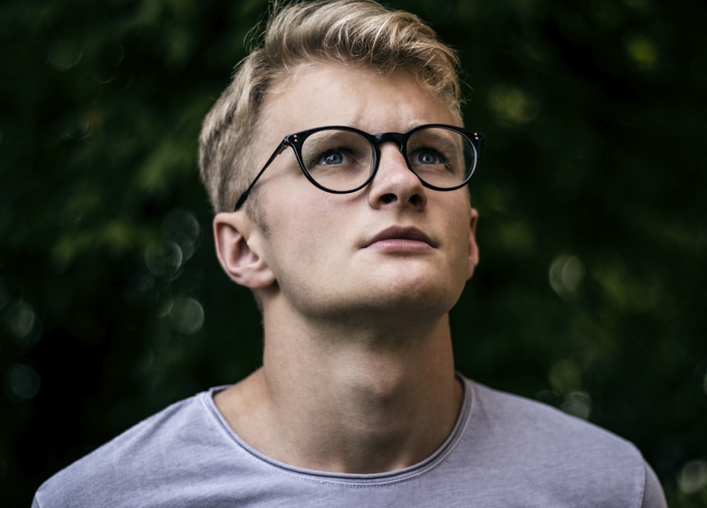 selective focus photography of man wearing eyeglasses