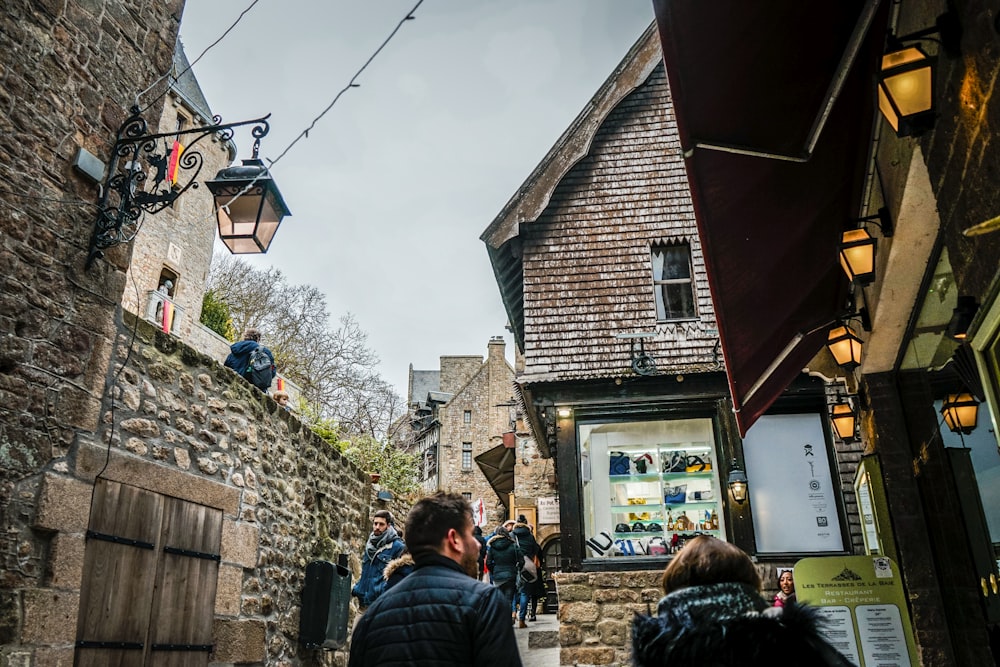 man and woman wearing black bubble jackets standing side by side near buildings