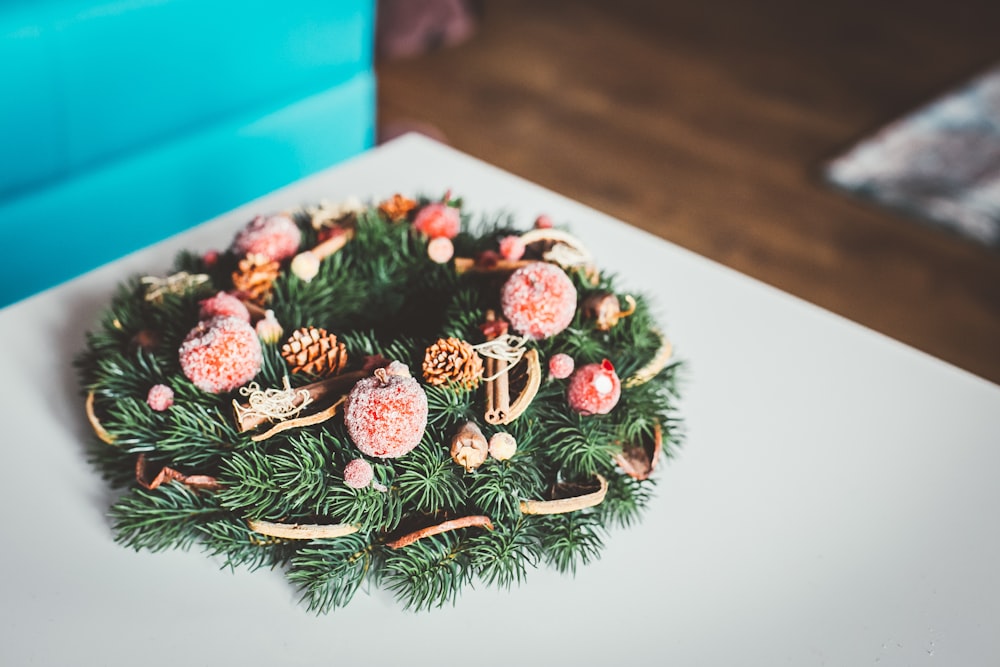 green and brown wreath on white surface