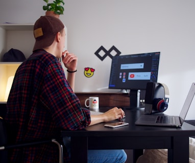 man sitting near table using computer