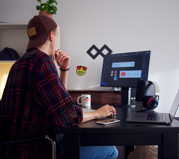 man sitting near table using computer