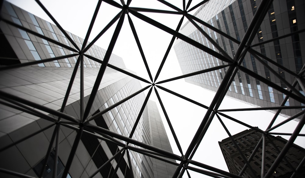 grey metal beams in between three tall buildings