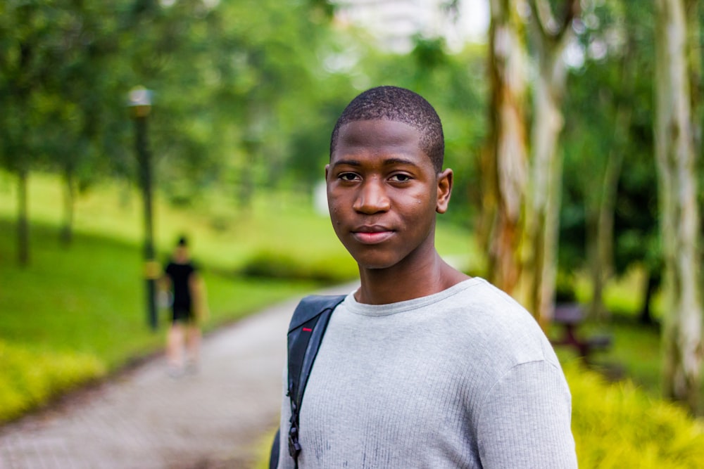 selective focus photography of man in gray crew-neck shirt