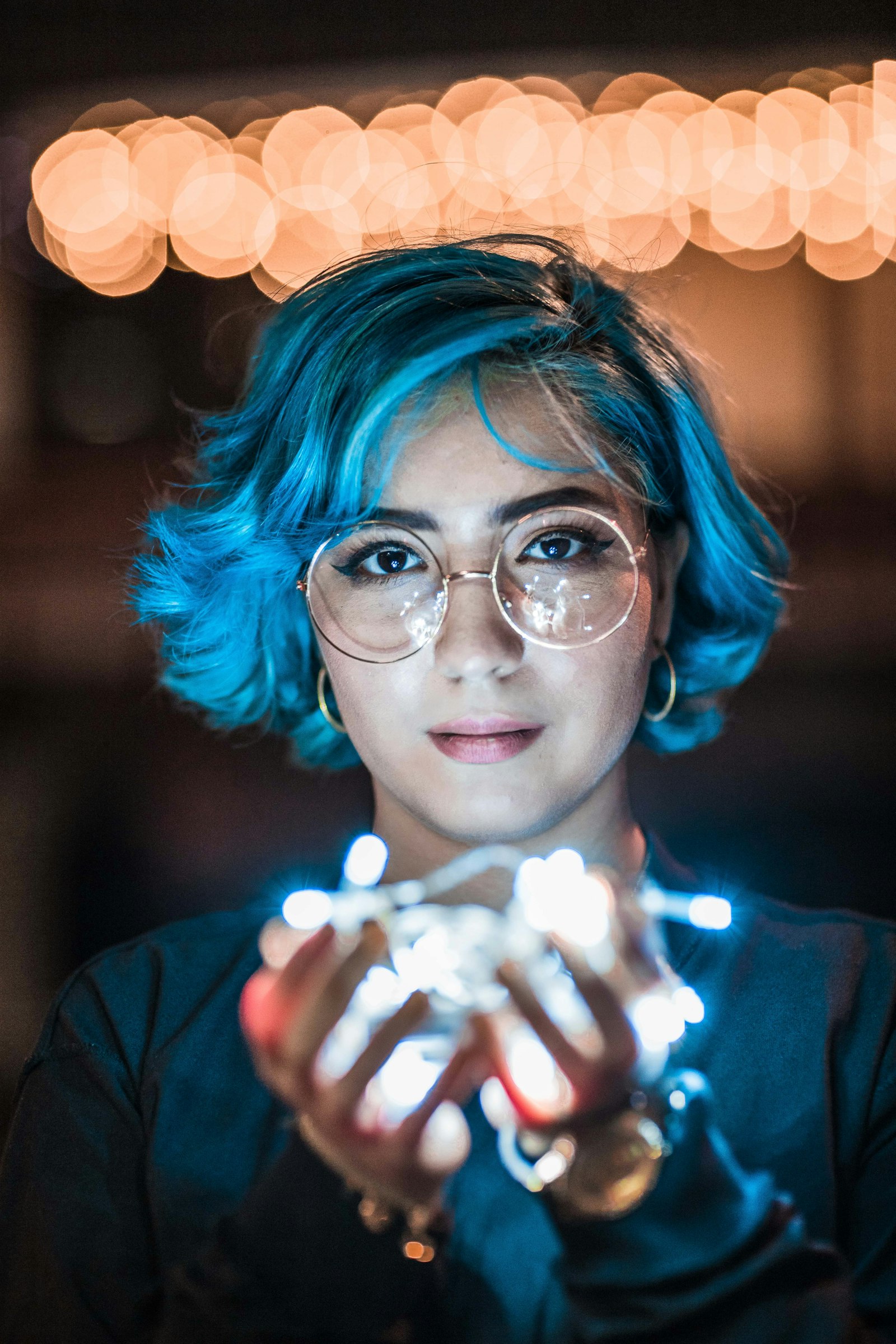 Canon EF 85mm F1.2L II USM sample photo. Blue short-haired woman holding photography