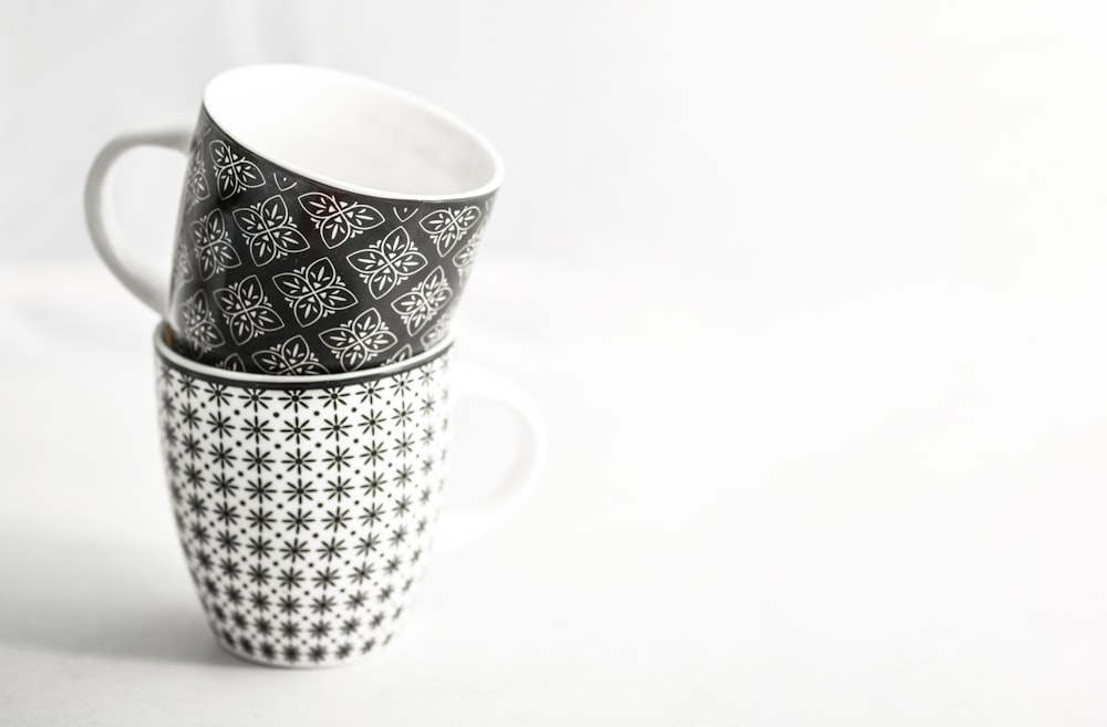 two white-and-black mugs