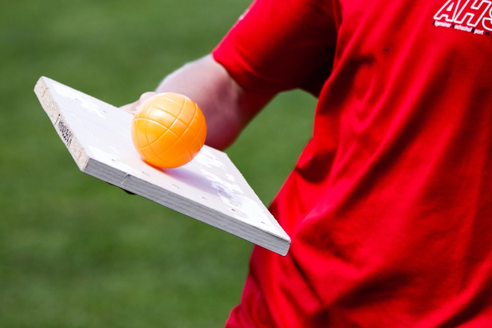 man balancing the orange ball