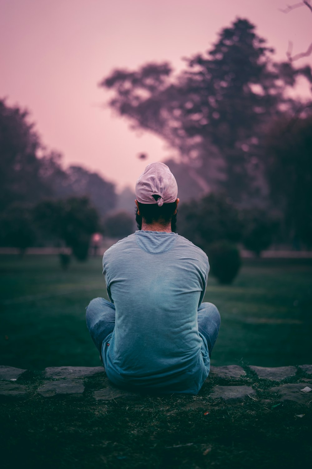 person in gray shirt sitting on ground