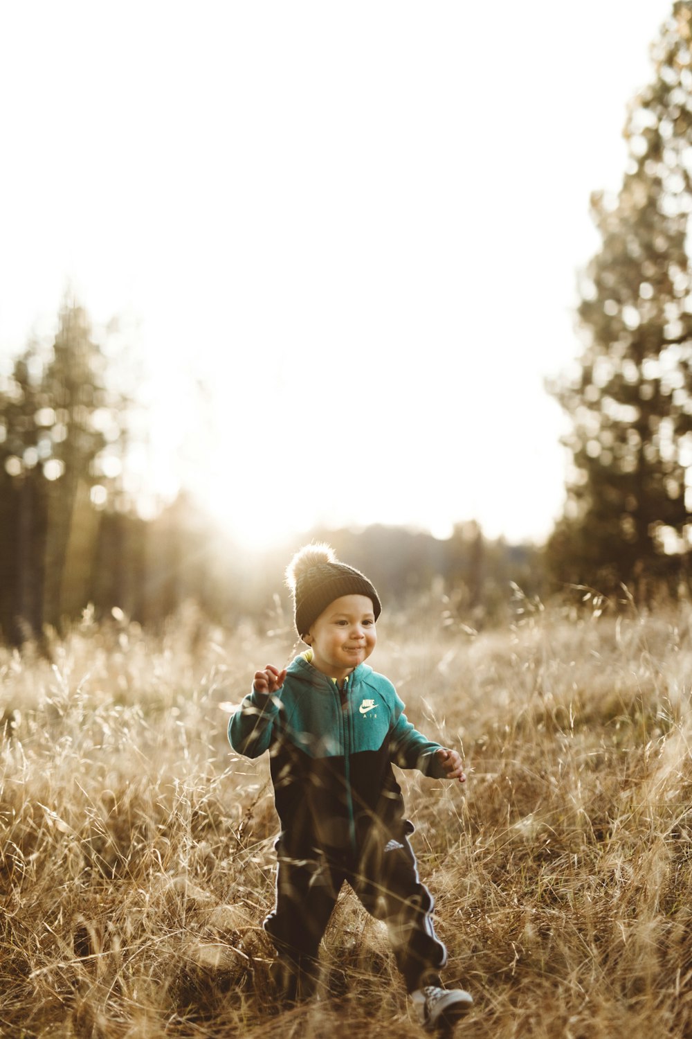 boy surrounded by grass