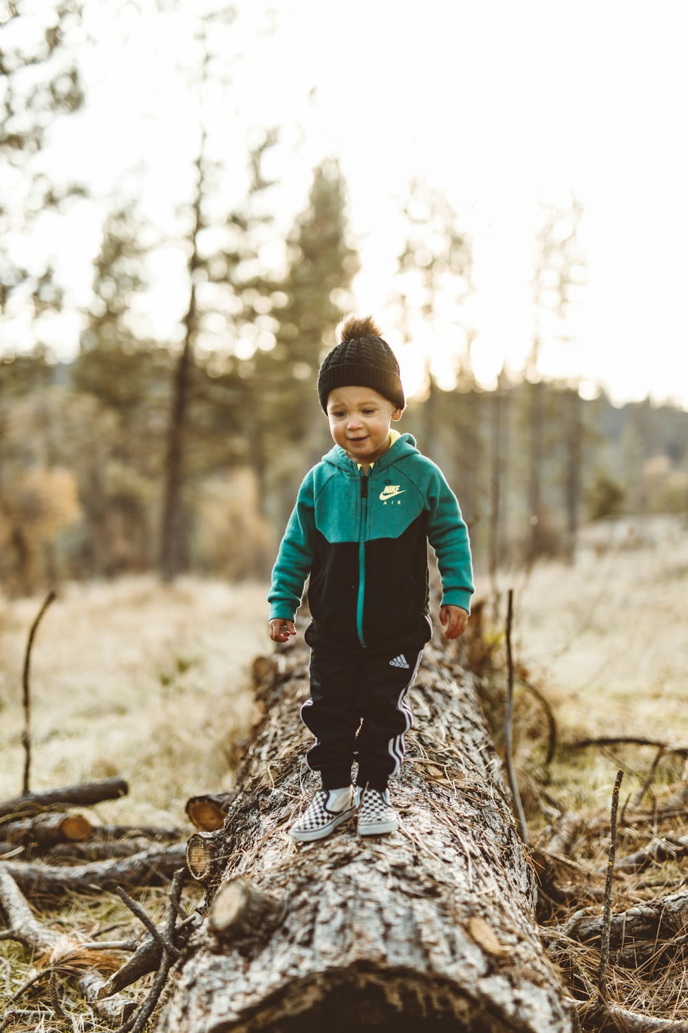 toddler on wood log